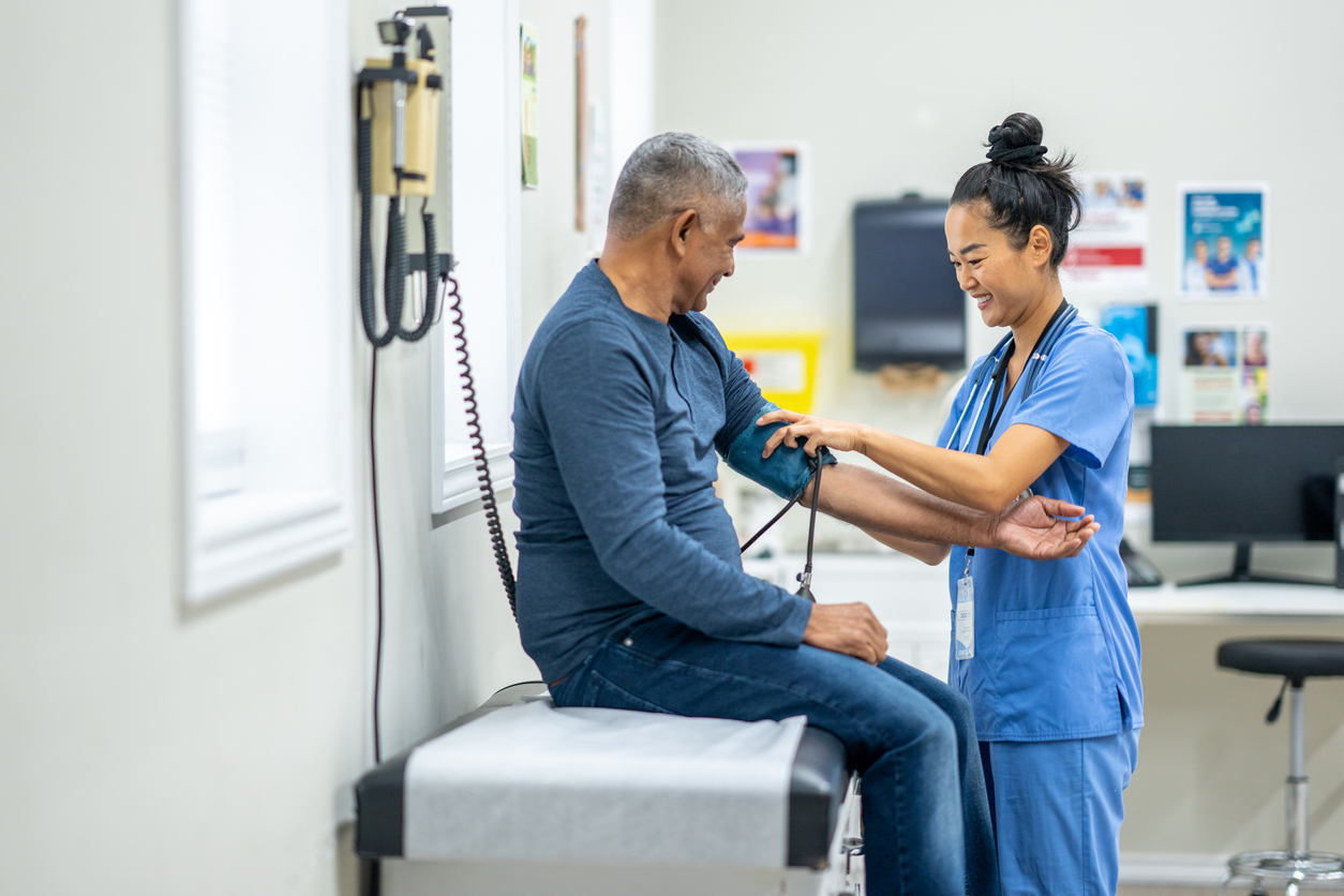 Healthcare worker reviewing clipboard with elderly patient