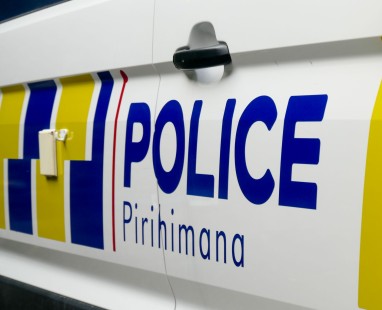 New Zealand Police car with white and yellow striped vehicle door