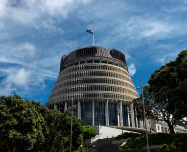 New Zealand Parliament building (Beehive) with distinctive circular architecture against cloudy blue sky