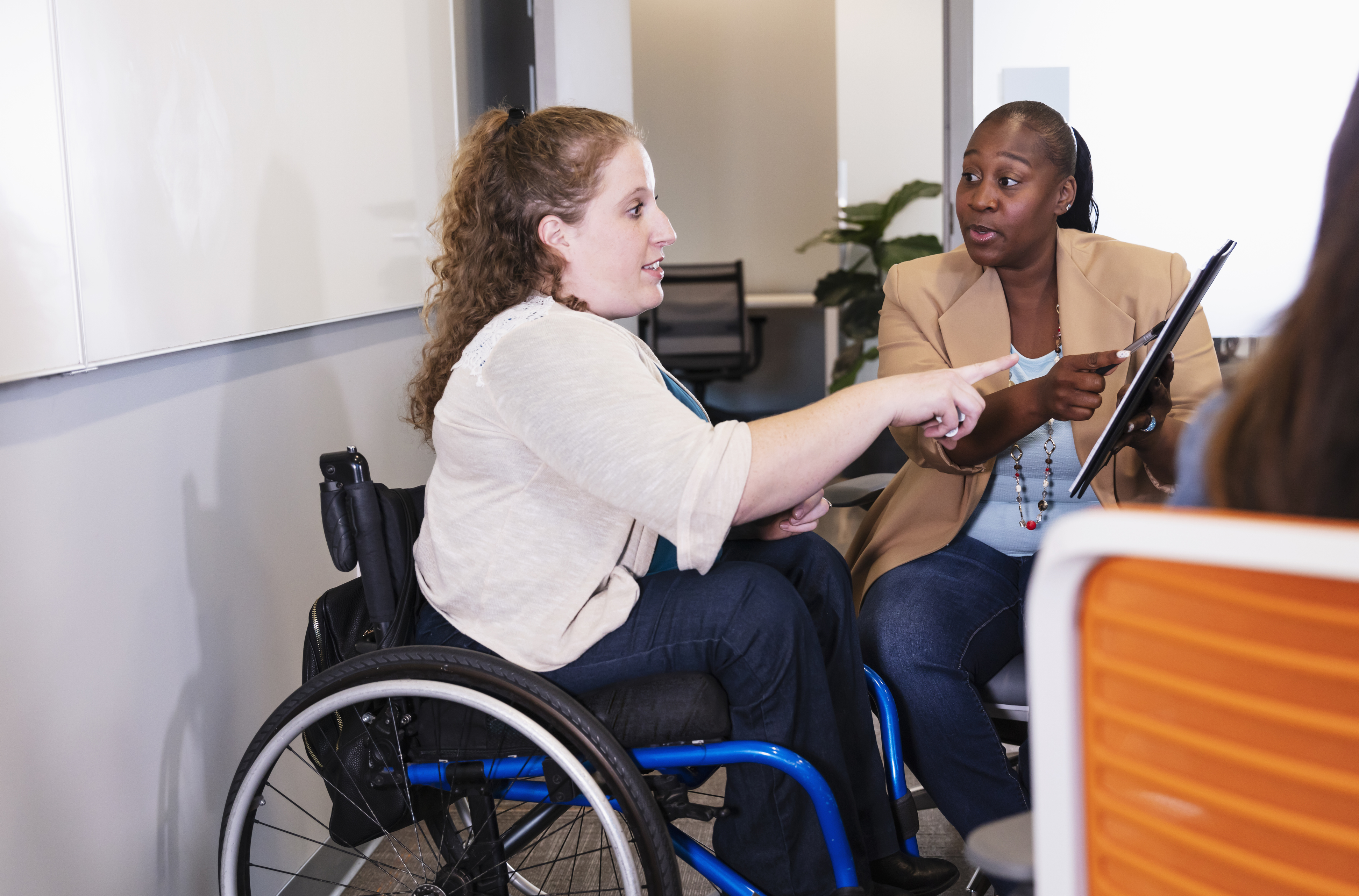 Person in wheelchair consulting with healthcare provider