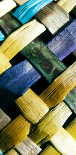  Woven harakeke strips in blue and yellow creating traditional pattern