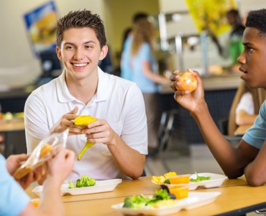 Friends sharing meal and conversation at bright cafe table