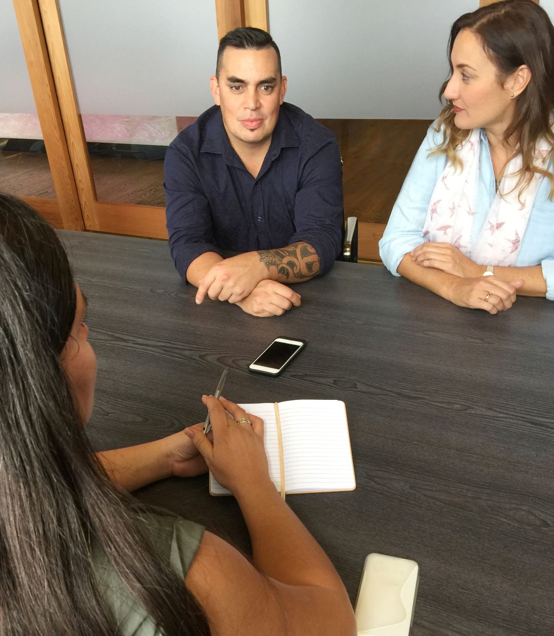 Group engaged in discussion around meeting table
