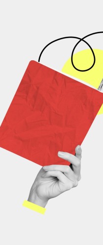 Hand holding red book with abstract yellow geometric shapes